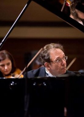 Paul-André Bempechat behind a piano while playing